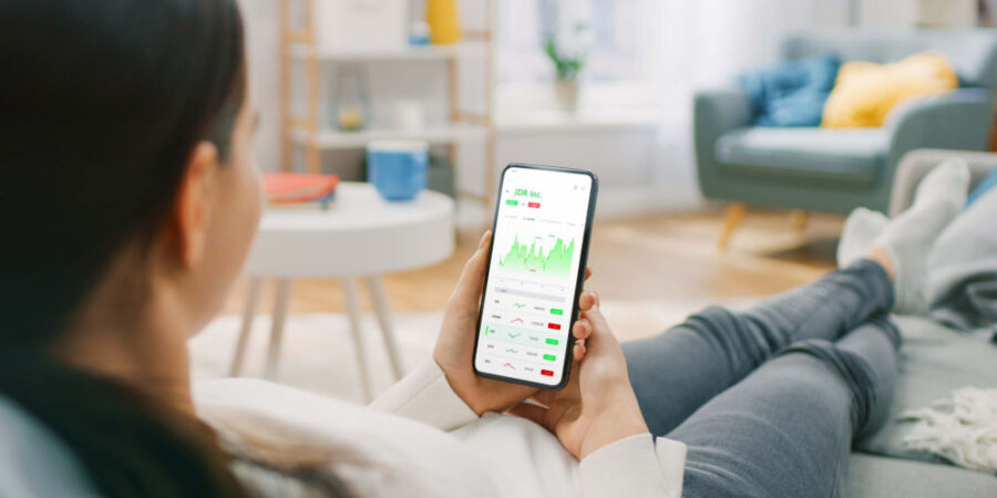 frau-wohnzimmer-aktien-app-smartphone_iStock-1350796011
