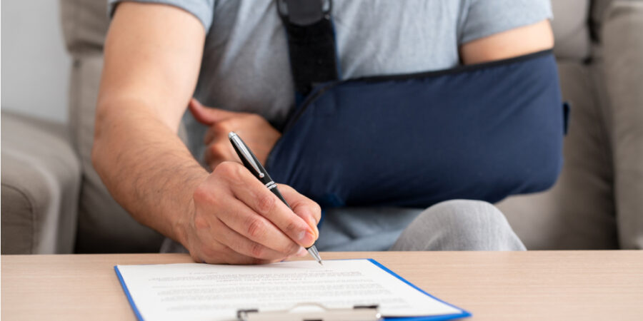 mann-arm-schlinge-vertrag_iStock-2183531170